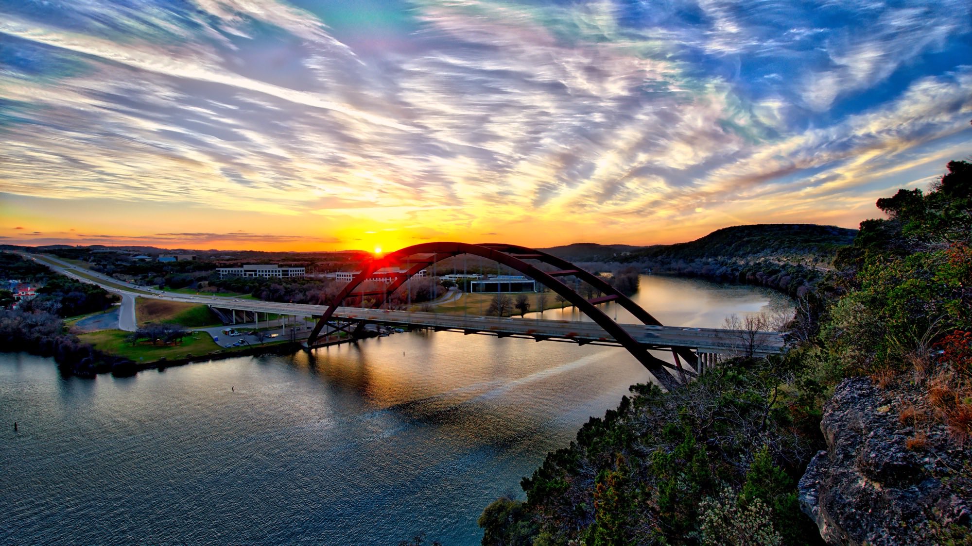 Pennybacker (360) Bridge over Lake Austin at sunset, shot from the Mount Bonnell-adjacent overlook, Hill Country ridgeline behind