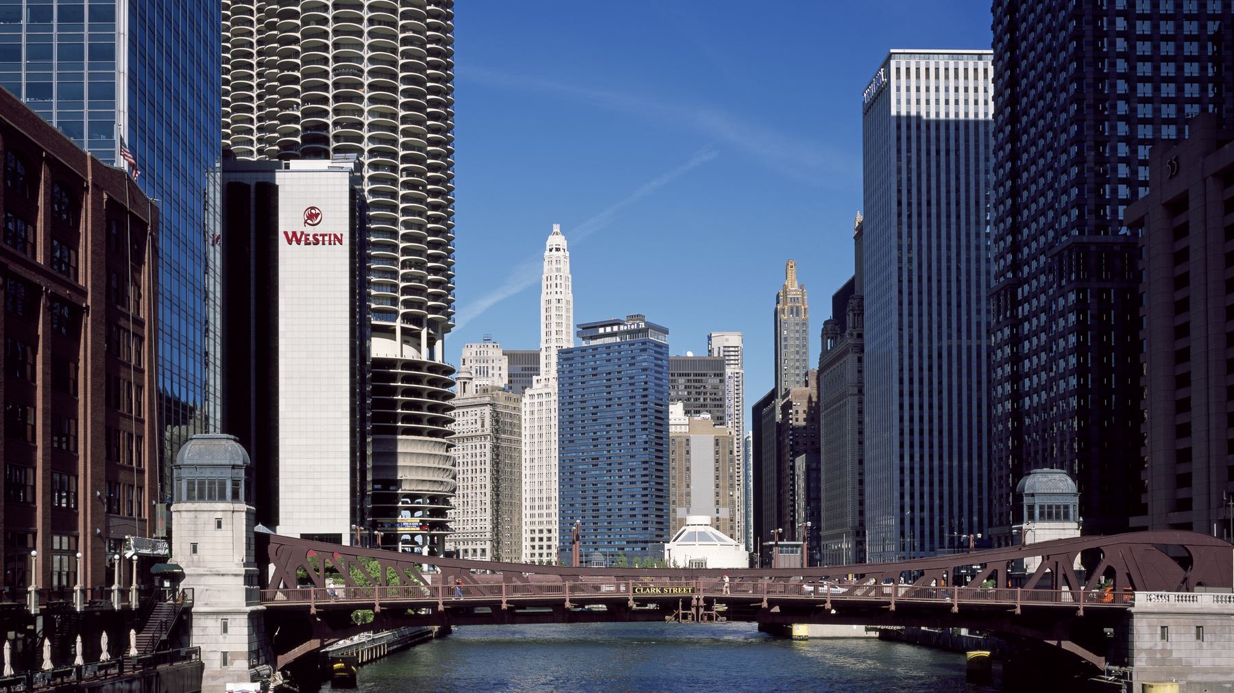 Chicago River canyon at Clark Street Bridge -- Marina City’s cylindrical corncob towers dead-center, the Westin Chicago River North, Wrigley Building clock towe