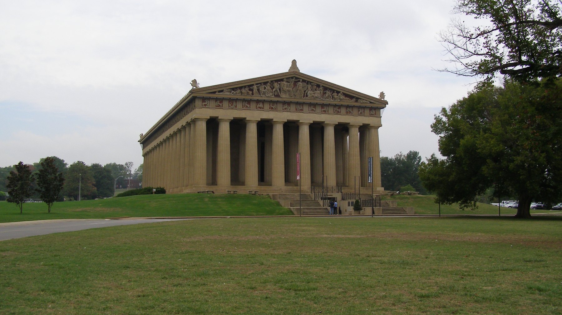 The Parthenon (full-scale replica), Centennial Park -- front facade with Doric colonnade, sculpted pediment frieze, and entrance stairs, overcast daylight -- br
